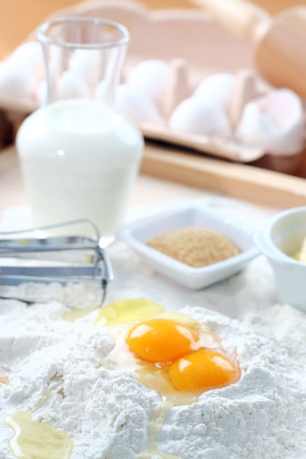 cake baking ingredients, including flour, sugar, eggs, milk, and butter