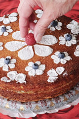 baker decorating a cake