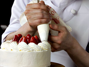 pastry chef decorating a cake