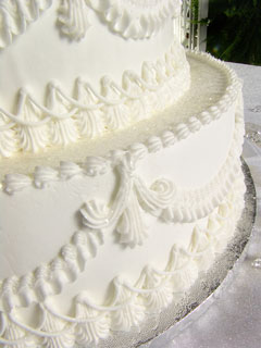 white wedding cake with icing designs